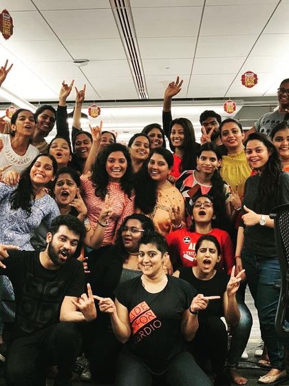 A duplicate shot capturing the amazing vibe with the Amazon team. The peace signs and rock-on gestures say it all. This is what a successful team-building activity feels like.