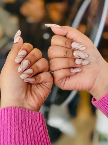 This design proves that elegance is in the details. I used a neutral, milky base on long almond nails and hand-painted delicate, sweeping gold lines to create a modern and sophisticated look.