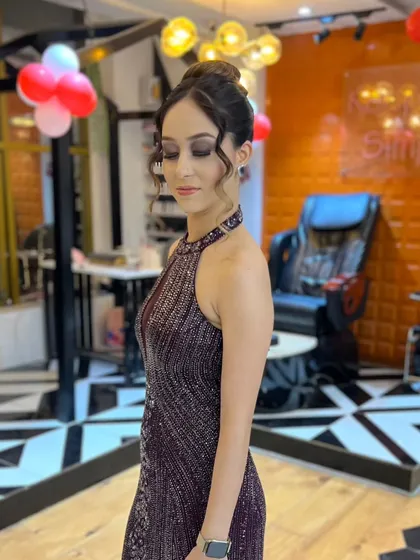 This is the perfect look for your next big event. We created this elegant party style featuring a shimmering smokey eye, a soft nude lip, and a beautifully crafted hair bun to complement the client's sequined gown.