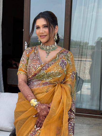 A full view of the client, showing how the ponytail hairstyle works with her entire look. It's a graceful and sophisticated choice.