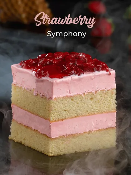 Our Strawberry Symphony ice cream cake. Layers of light sponge and refreshing strawberry ice cream, topped with a sweet strawberry compote.
