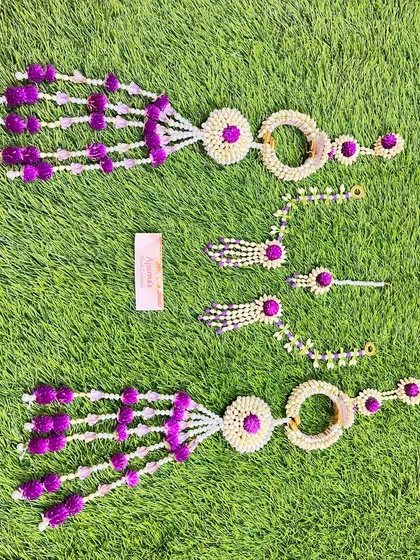 Another view of the purple and white Mehendi jewellery set, laid out on a banana leaf to highlight the fresh materials.