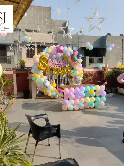 A wider view of the fairy-themed terrace party, showing the full setup with star-shaped lights and ample space for guests.