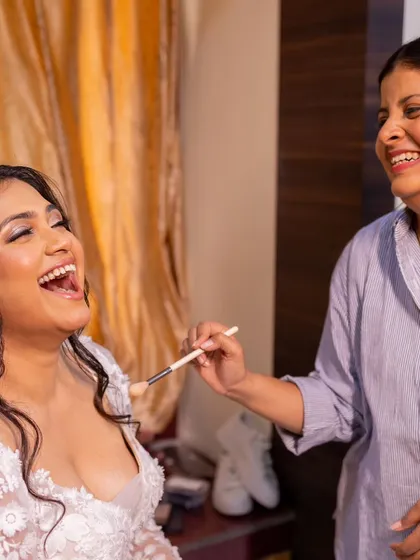 The best part of my job is the connection and joy shared on a wedding morning. This candid moment of laughter is what it's all about: creating a relaxed, happy atmosphere while I bring your bridal vision to life.