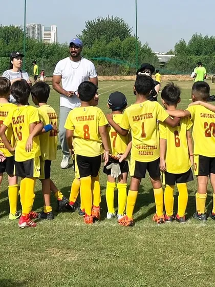 A coach with his team. We foster a love for the game and empower each player to reach their fullest potential.