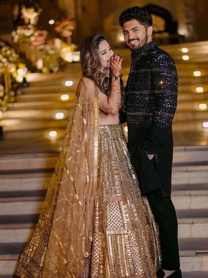 A glamorous portrait of Ishita and Akash on their engagement night, their sparkling outfits matching the festive atmosphere.