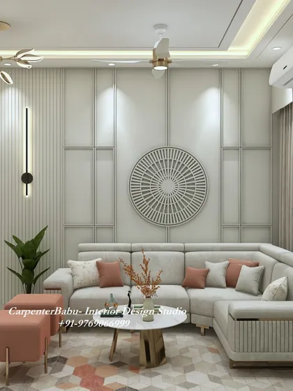 This living room uses a soft, peachy-pink color in the ottomans to add warmth to the neutral space. The wall paneling and large circular art piece create a sophisticated backdrop.