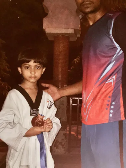 This young blue belt holder stands proudly with his medal. It's rewarding to see students progress and succeed at every level of their training.