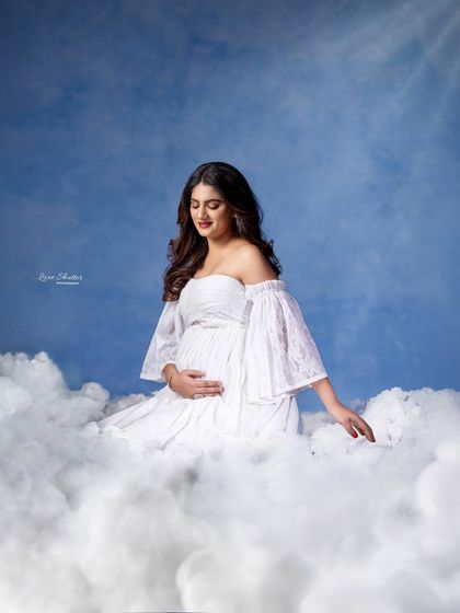 Another beautiful shot from my "heavenly clouds" concept, this time with the mom-to-be looking down at her bump with love.