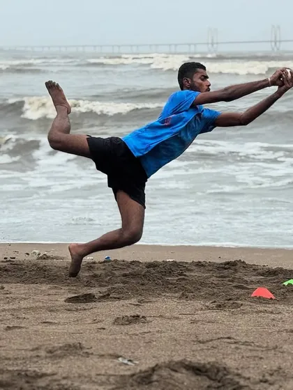 Full commitment in the air. This image captures the athleticism and body control we instill in our fielders during our intense beach training sessions.