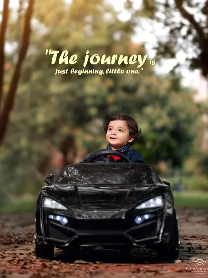 The journey is just beginning, little one. A forward-looking toddler at the wheel of his toy car, ready for the road ahead.