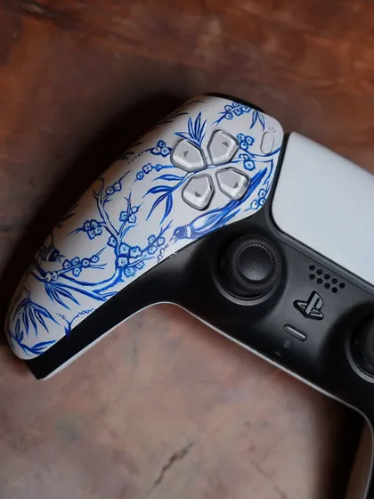 A detail shot of the D-pad side of the porcelain-inspired PS5 controller.