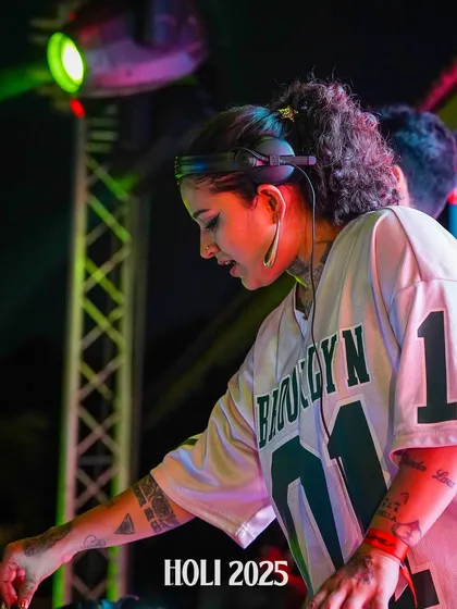 A close-up of me focused on the mix during a Holi set.