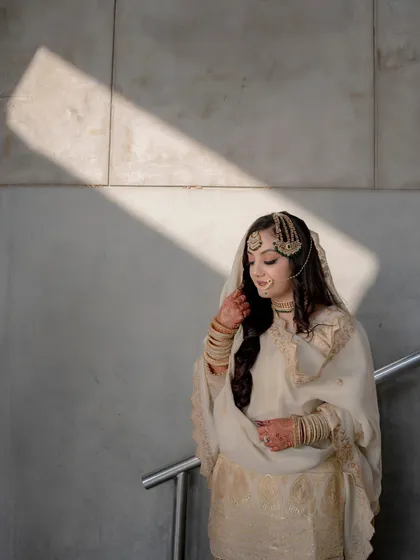 A solo portrait of Lubna, with a dramatic shadow falling across the frame, creating a moody and artistic image.