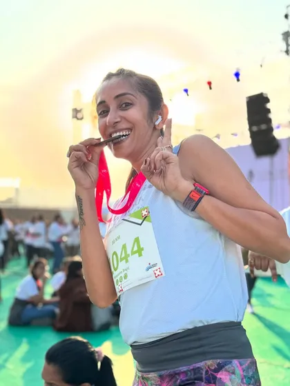 Biting the medal! A moment of pure joy and fun after completing the Go Flo Run.