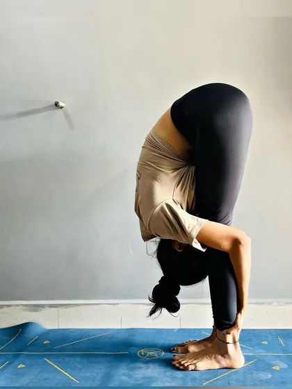 Every practice brings progress. This is a deep forward fold (Uttanasana), a fundamental yoga pose that stretches the hamstrings and calms the mind.