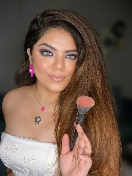 Just a vibe. Sipping coffee and feeling pretty in a smokey eye and off-shoulder top.