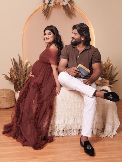 A beautiful couple's portrait in our studio. The rich color of the Renee gown complements the neutral tones of the boho backdrop perfectly.