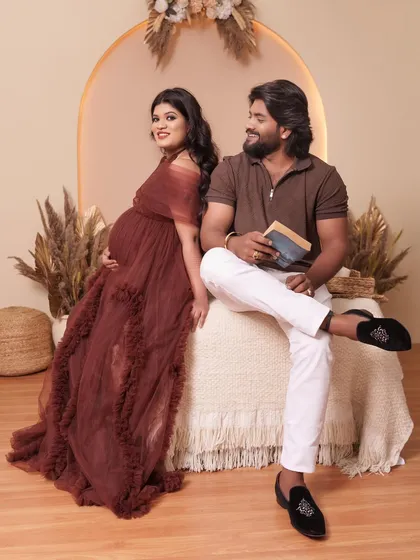 A beautiful couple's portrait in our studio. The rich color of the Renee gown complements the neutral tones of the boho backdrop perfectly.