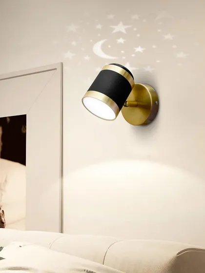 The star-projecting wall light can be angled to direct the light, making it a versatile reading lamp for a bedroom or a cozy nook.