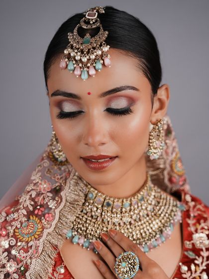 This pastel-themed bridal look was created by a student, showcasing their ability to work with modern color palettes and create soft, elegant makeup.