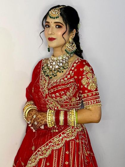 A three-quarter view of Akanksha, showing off her beautiful makeup and the floral braid hairstyle.