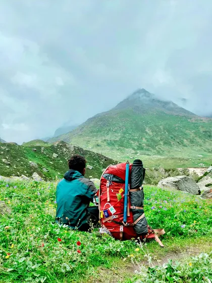 A moment of solitude on the Pin Parvati trek, with a backpack full of essentials and a mountain full of dreams.
