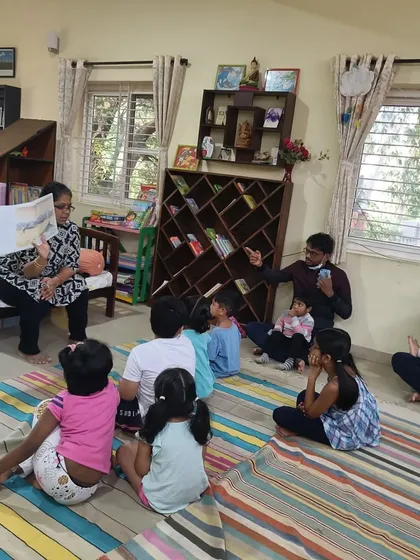 A wide view of the dolphin story session, with parents and children learning together.