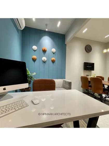 The principal architect's desk in our studio. The clean, modern workspace is designed for focus and creativity, with a view of the entire studio to foster a collaborative environment.