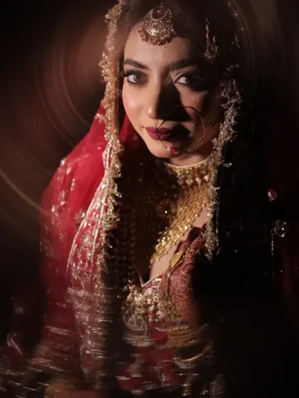 A moody and captivating bridal portrait. The circular light effect draws all attention to her expressive eyes and the rich details of her wedding attire.