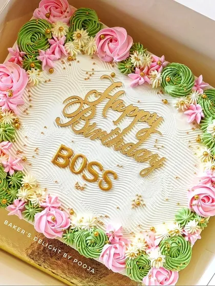 A beautiful floral sheet cake for a "Happy Birthday Boss" celebration. The piped rosettes in pink and green make it an elegant option for a corporate event or large office party.