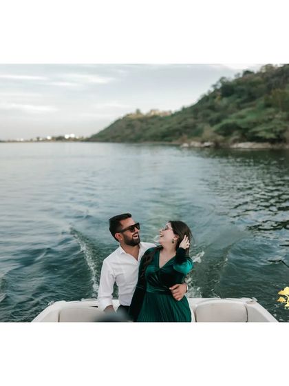 A happy, candid moment on the boat. The wake of the boat and the bride's joyful laugh make this a dynamic and heartwarming photo.
