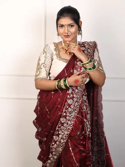 The rich texture of the maroon velvet Nauvari is evident in this shot, along with the sparkle of the embroidery.