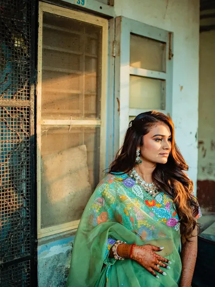 A beautiful candid shot of the bride during golden hour, her soft waves catching the light perfectly.