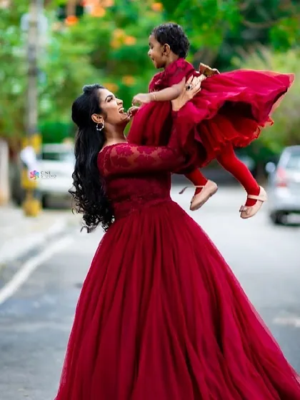 Because family is everything. I offer matching mother-daughter gowns to make your family portraits even more special. This joyful moment is captured perfectly with our coordinated red dresses.