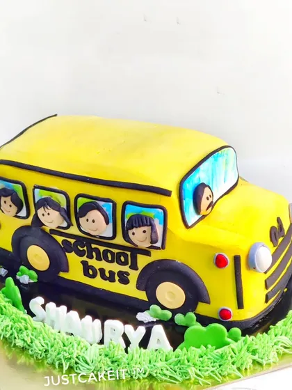 A whipped cream school bus cake. This is a great example of a sculpted cake made without fondant, focusing on piped details.