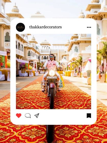 A grand entrance for a royal-themed wedding, featuring a long, ornate red carpet leading through a palatial courtyard. The groom's entry on a motorcycle adds a modern twist.
