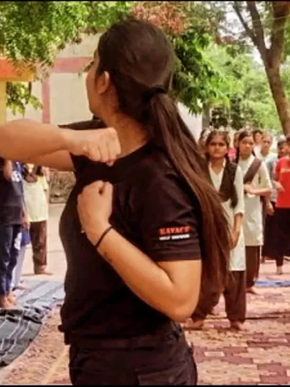 A female instructor leading a self-defense session for underprivileged girls through an NGO partnership.