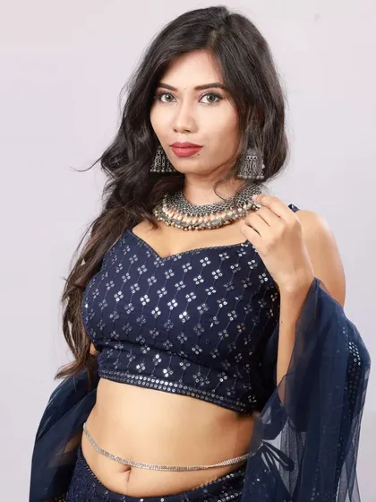 A close-up studio portrait focusing on the model's expression and the statement oxidized jewellery. This highlights the complete styling of the look.