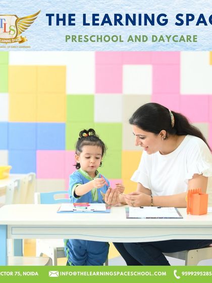 A teacher provides one-on-one guidance in our colorful classroom. This image captures the personal attention and nurturing support that is central to our teaching philosophy.