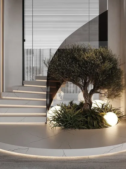A curved mirror behind this faux olive tree installation creates the illusion of a larger space. The tree is nestled in a custom-built planter that follows the curve of the wall, showcasing our bespoke capabilities.