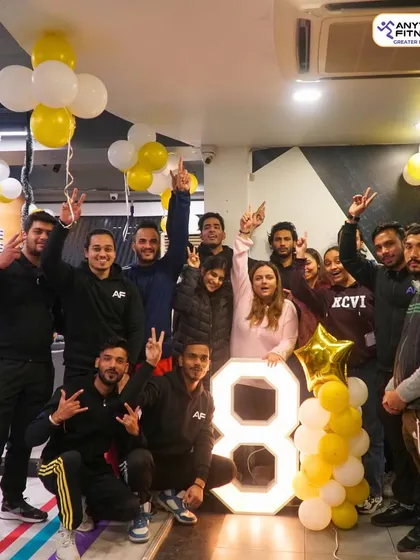 The team and members celebrating 8 years of fitness and community.