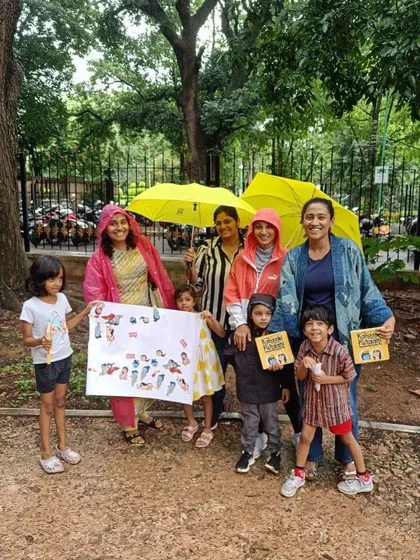 Our dedicated little group braving a rainy day for a Diwali story session. This photo, with everyone huddled under umbrellas, shows the wonderful commitment of our community.