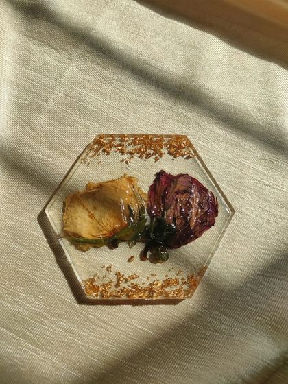 A top-down view of the preserved dual-rose coaster, showing the delicate details of the flowers. Each piece is handmade and captures the unique beauty of your memories.