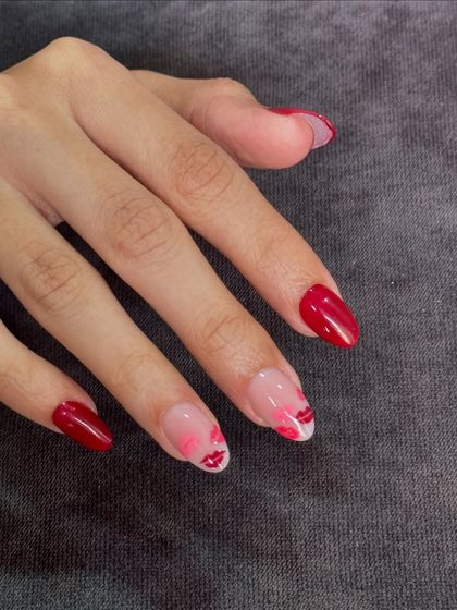 Minimal effort, maximum impact. A classic red manicure with two accent nails featuring cute, hand-painted lips.