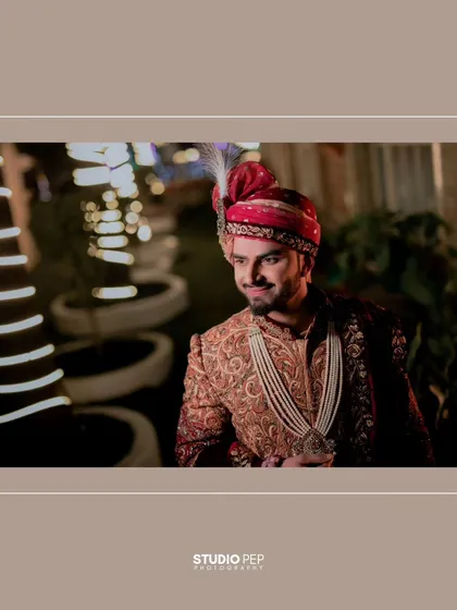 A stylish, wide-shot of Akhilesh, his portrait framed by the elegant decor of the wedding venue.