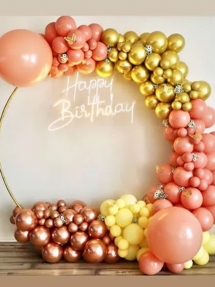 A bright and cheerful ring backdrop for a birthday celebration. The warm tones of peach, yellow, and gold chrome balloons create a sunny and inviting atmosphere.
