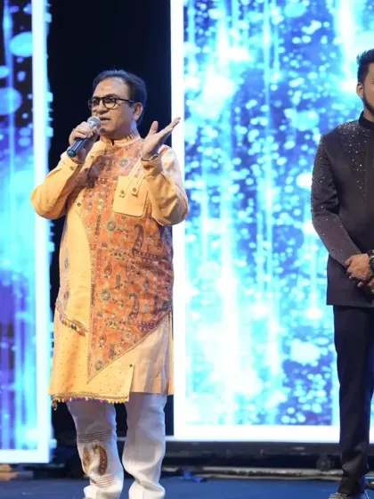 On stage with celebrity guest Dilip Joshi as he shares some words of wisdom with the happy couple during their Sangeet.
