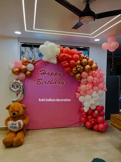 The complete view of the pink-themed birthday decoration.