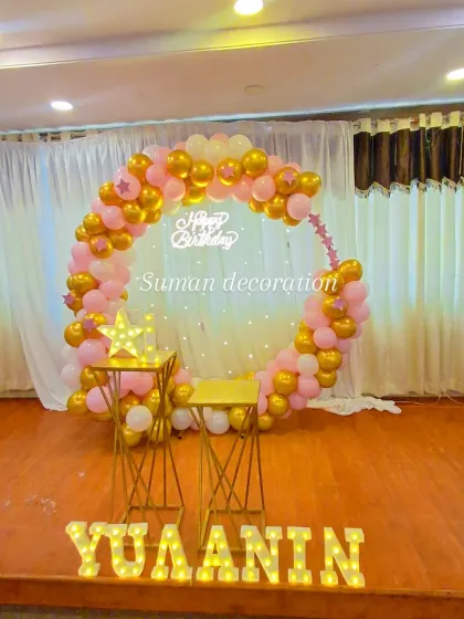 A centered view of the pink and gold stage decoration, perfect for photos and cake cutting.